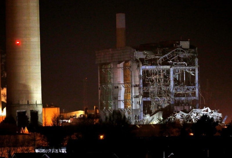 Part of a collapsed building is illuminated by the emergency services as they work at the decommissioned Didcot A power station in central England, February 23, 2016. REUTERS/Peter Nicholls
