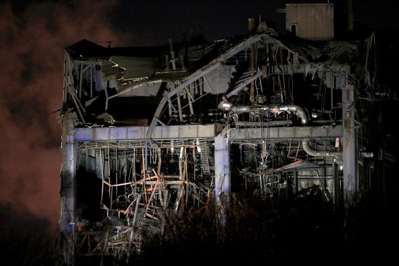 Part of a collapsed building is illuminated by the emergency services as they work at the decommissioned Didcot A power station in central England, February 23, 2016. REUTERS/Peter Nicholls