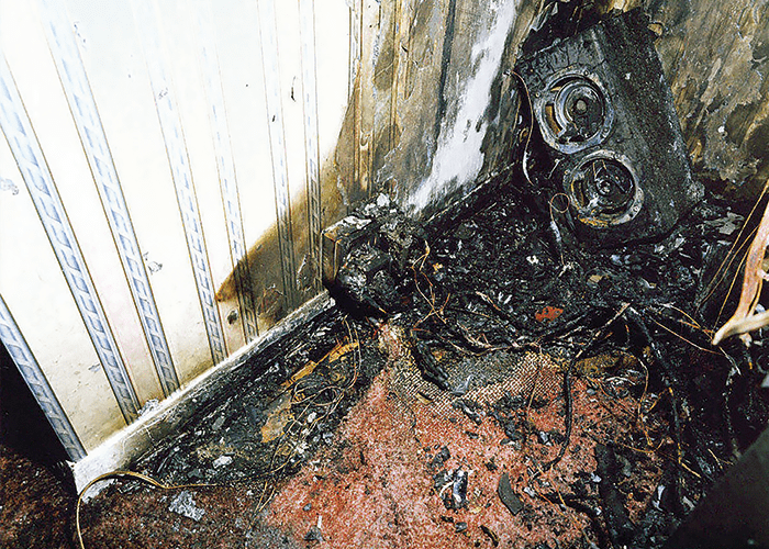 A fire caused by an overloaded electrical circuit though the use of too many plugs.