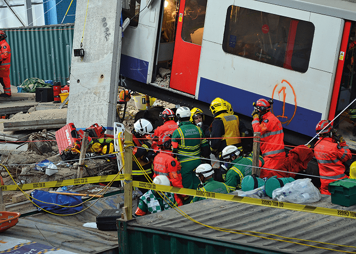 Fire & Rescue and Paramedic crews work to release casualties trapped in the wreckage of the Underground train.