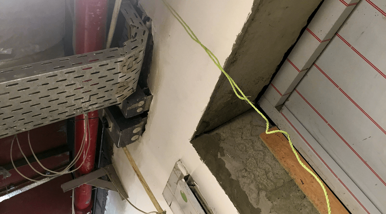 Unsealed horizontal penetration in the service areas of an under construction hotel building. These unsealed penetrations will cause smoke to propagate from one area to another.