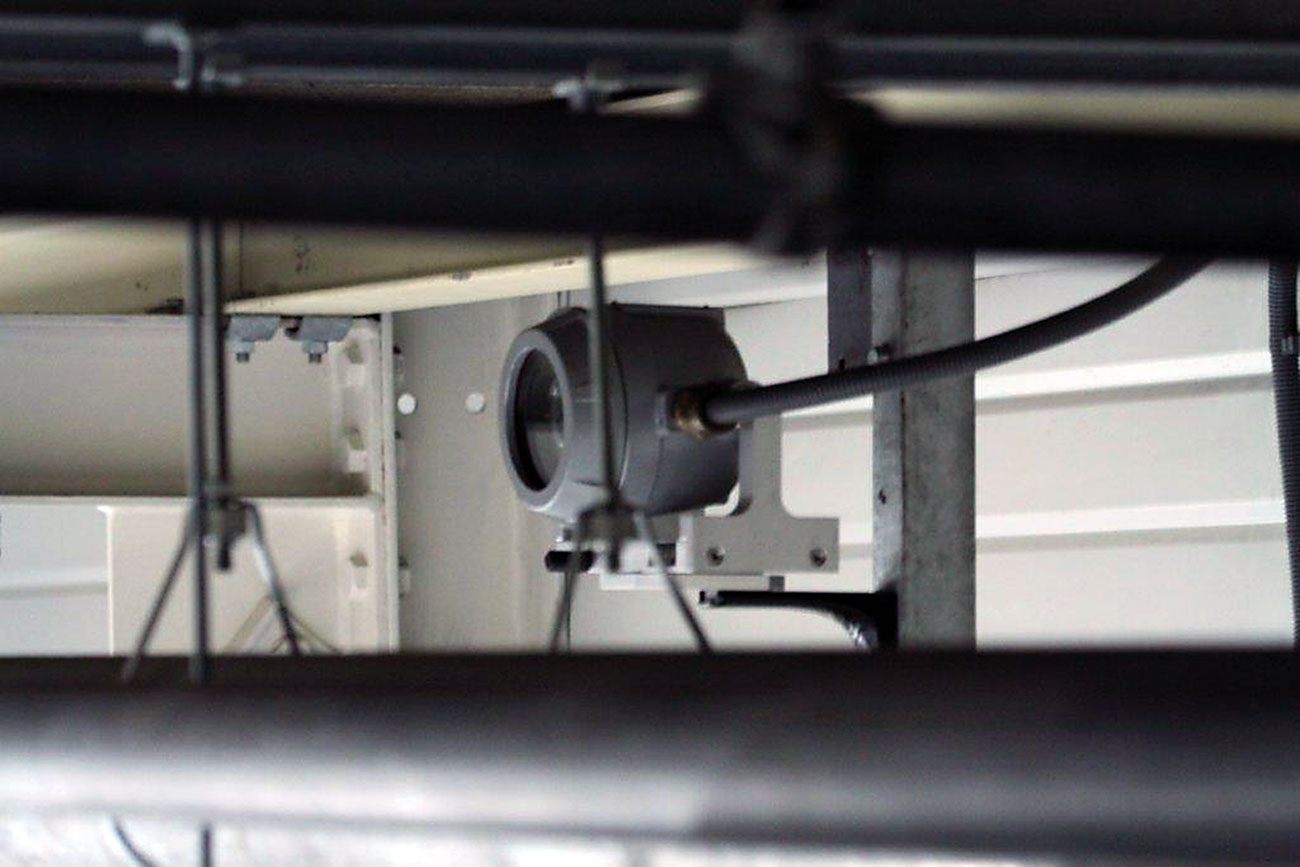 The pictures show a beam detection system installation in an oil plant passing through pipes in a classified ATEX area.